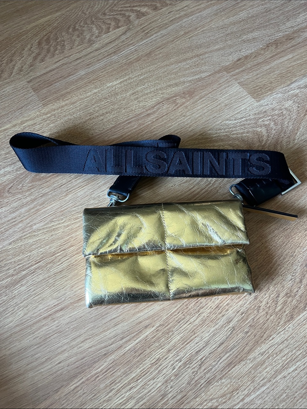 All Saints Metallic Gold Crossbody Bag with Black Logo Strap